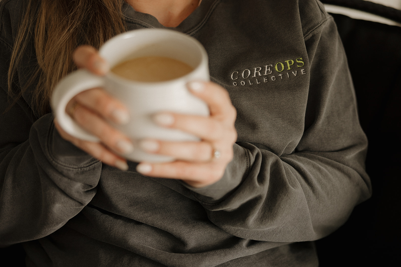 CoreOps Collective woman holding coffee cup